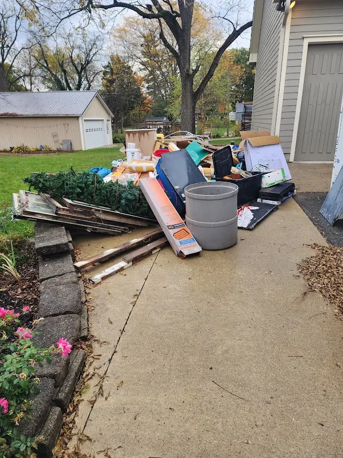 Dumpster being loaded with debris for Estate Cleanout Dumpster Rental in Bethesda